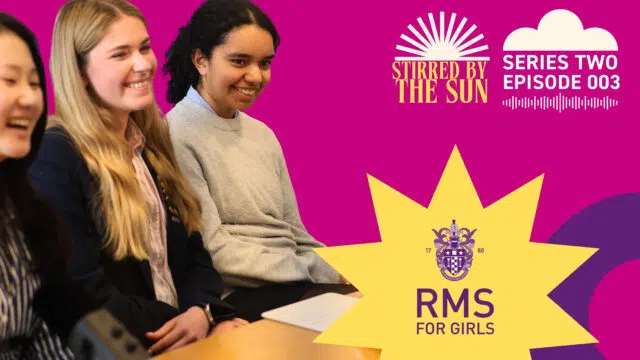 Group of smiling girls seated together in front of a bright magenta banner featuring the 'RMS for Girls' emblem and 'Stirred by the Sun' logo.