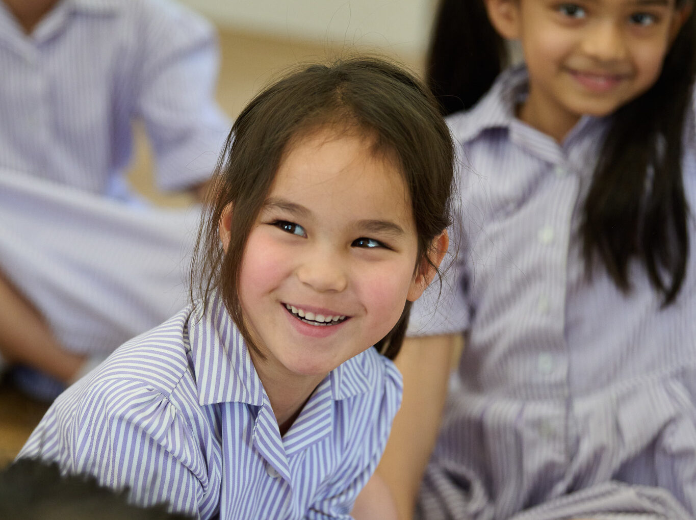 What are the benefits of an all-girls education? A smiling RMS pupil enjoys listening to her teacher.