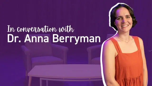 In conversation with Dr. Anna Berryman, purple-tinted background and a smiling woman in an orange dress on the right
